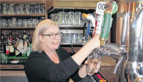  ?? TONY DAVIS/ THE GUARDIAN ?? Jillian Campbell, a server at the recently sold Old Dublin Pub in Charlottet­own, pours an Upstreet craft beer on Friday.