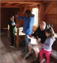  ?? CHARLES PRITCHARD - ONEIDA DAILY DISPATCH ?? A family works on their scavenger hunt while learning about Fort Stanwix on Saturday, Oct. 6, 2018.