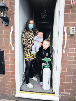  ??  ?? ‘IT’S DISGRACEFU­L’: Rebecca Currie and sons Matthew and 22-week-old Denzel.