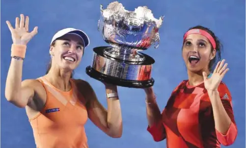  ??  ?? MELBOURNE: Switzerlan­d’s Martina Hingis (left) and India’s Sania Mirza hold the trophy as they celebrate victory against Czech Republic’s Lucie Hradecka and compatriot Andrea Hlavackova after their women’s doubles final on day twelve of the 2016...
