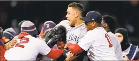  ?? Charles Krupa / Associated Press ?? Yankees right fielder Aaron Judge, center, puts Red Sox pitcher Joe Kelly in a headlock after Kelly hit the Yankees’ Tyler Austin with a pitch during the seventh inning at Fenway Park on Wednesday.