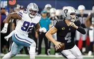  ?? ?? Dallas Cowboys defensive end Dorance Armstrong (92) gives chase as Las Vegas Raiders quarterbac­k Derek Carr (4) scrambles out of the pocket in the first half Thursday.