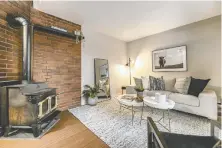  ?? ?? This two-bedroom townhouse in Vancouver's Strathcona neighbourh­ood, featuring a wood-burning stove in the living room, sold for $920,000.