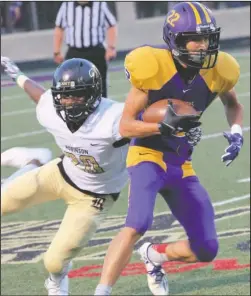  ?? The Sentinel-Record/Corbet Deary ?? COBRA CORRALLED: Fountain Lake junior Ahman Johnson (22) runs the ball as Joe T. Robinson’s Tyler Jones (20) defends Friday night on Allen Tillery Field at Beckham Memorial Stadium. Robinson held the Cobras to 131 yards of total offense in a 49-14 win.