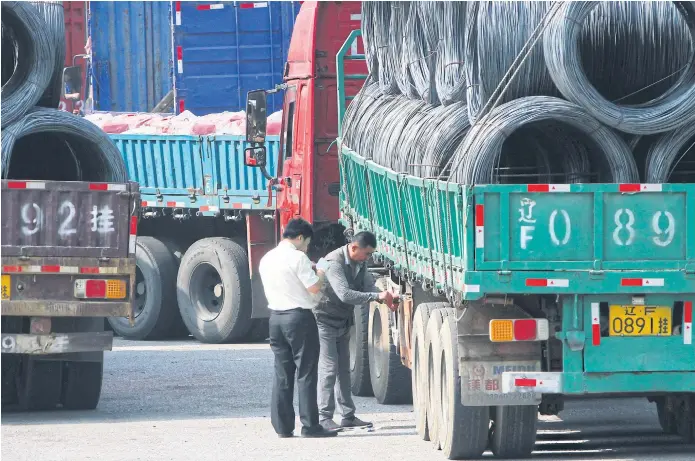  ??  ?? UNDER SCRUTINY: Chinese customs officials inspect trucks loaded with goods to and from North Korea in Dandong in northeast China’s Liaoning province.