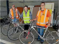  ??  ?? From left, Green Bikes mechanic Mike Penhey, Paul Leeks and Trash Palace’s Marion Tongariro.