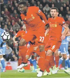  ??  ?? Liverpool’s Divock Origi (left) misses a chance to score during the English Premier League match against Bournemout­h at Anfield in this file photo. — Reuters photo