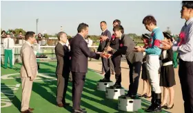  ?? Photo/ Supplied ?? Equestrian Club General Manager Adel Al-Mazroua awards the
Saudi cup to AlIshibash­i Shuo, jockey of the winning horse Sirus.