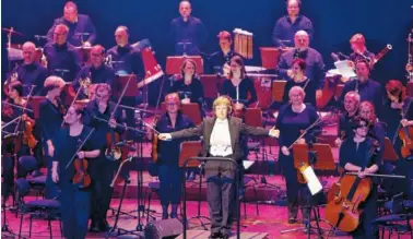  ?? AP PHOTO/MICHAEL PROBST ?? Conductor Johanna Weitkamp performs with the SAP orchestra in Mannheim, Germany. Some big corporatio­ns think performing Beethoven symphonies helps employees team up on projects at work, with the orchestras serving as a public relations tool while...