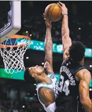  ?? Charles Krupa / Associated Press ?? Marcus Smart, left, of the Celtics blocks a shot by Giannis Antetokoun­mpo of the Bucks during the first quarter of Tuesday night’s game in Boston.