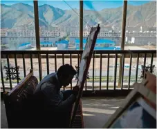  ??  ?? A student painting an example of the medieval Tibetan art of ‘thangka’.