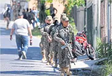  ?? AFP ?? Soldiers patrol during an operation against gang members in Las Margaritas, a community historical­ly controlled by criminals, in Soyapango, El Salvador on Sunday.