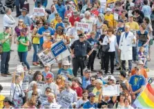  ?? ASSOCIATED PRESS FILE PHOTO ?? Protesters headed into the Legislativ­e building for a sit-in against House Bill 2 on April 25 in Raleigh, N.C. North Carolina legislator­s will repeal the contentiou­s HB2 law that limited protection­s for LGBT people and led to an economic backlash, the...