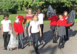  ?? ?? Pupils litter picking at The Mighty Girls afterschoo­l club