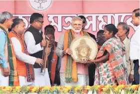  ?? PHOTO: PTI ?? PM Narendra Modi at a rally near Agartala asked people to throw away the ‘Manik’ (gemstone), a reference to CM Manik Sarkar, and choose the ‘Hira’ — highway, I-way, railway and airways