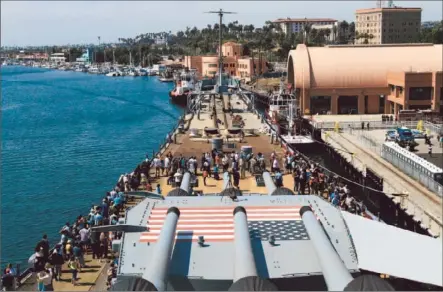  ?? Photograph­s by Irfan Khan
Los Angeles Times ?? A LINE OF VISITORS snakes around the massive gun deck of the Iowa. A single route took them through a wardroom where officers ate and relaxed, around the vessel’s upper decks and through the captain’s quarters that once hosted President Franklin D....