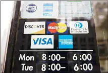  ??  ?? This file photo shows credit card logos posted on a store’s door in Philadelph­ia. The SMART acronym calls for goals to be specific, measurable,
assignable, realistic and time-related. (AP)