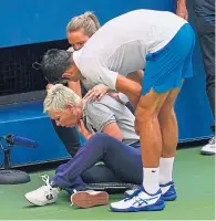  ??  ?? Disqualifi­ed: Novak Djokovic rushed over to check on the line judge’s condition after hitting her with a ball