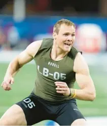  ?? MICHAEL CONROY/AP ?? Iowa linebacker Jack Campbell, who could interest the Dolphins in the draft, runs a drill at the NFL scouting combine in Indianapol­is on Thursday.