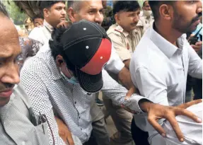  ?? ?? MOHAMMED ZUBAIR being escorted by the Delhi Police at the Patiala House Courts in New Delhi on June 28.