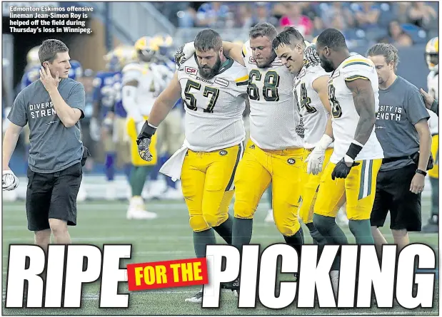  ??  ?? Edmonton Eskimos offensive lineman Jean-Simon Roy is helped off the field during Thursday’s loss in Winnipeg.