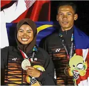  ?? — Reuters ?? Pure class: Terengganu’s Nuur Fatin Solehah Abdul Rahman (left) and Ilham Wahab.