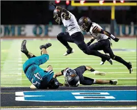  ?? ELIZA GREEN / THE CALIFORNIA­N ?? Jaikel De Leon from Kennedy High tumbles into the end zone for a Thunderbir­d touchdown in the first half of Friday’s game against Delano’s Chavez High.