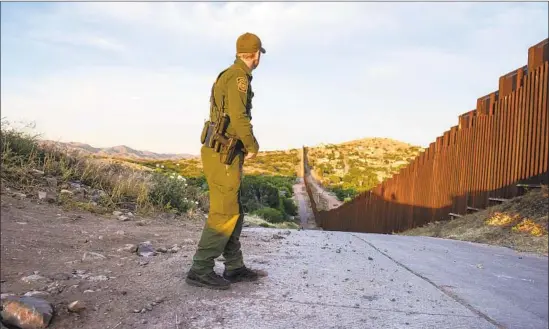  ?? Photograph­s by Steve McCurry ?? A U.S. BORDER PATROL officer patrols the wall at Nogales, Ariz. The image illustrate­s a new book by Paul Theroux, who passes deep beyond the wall into Mexico.