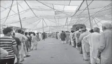  ??  ?? LAHORE
A large number of people standing in queue for purchasing sugar on subsidized rates at Sasta Ramzan Bazaar. -APP