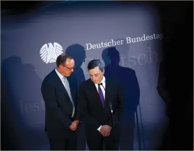  ?? (Axel Schmidt/Reuters) ?? EUROPEAN CENTRAL BANK President Mario Draghi (right) and an interprete­r attend a news conference after a meeting with German lawmakers in Berlin yesterday. He said Germans are net beneficiar­ies of the ECB’s policies, and action from government­s,...