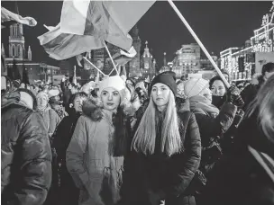  ?? NANNA HEITMANN/THE NEW YORK TIMES ?? People wave Russian flags Monday at a rally in Moscow’s Red Square marking the 10th anniversar­y of Russia’s illegal annexation of Crimea from Ukraine. Speaking at the rally, Russian President Vladimir Putin indicated the war in Ukraine remains the focus of his administra­tion.