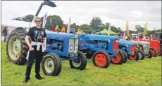  ??  ?? Councillor Alastair Redman with some of the vintage tractors at Islay Show.