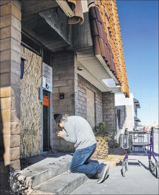  ?? L.E. Baskow Las Vegas Review-Journal ?? Earl Betts delivers fresh flowers and pays his respects to friends lost during the recent fire at the Alpine Motel Apartments on Monday. He makes the same trek once or twice daily, as he lived nearby in the past.