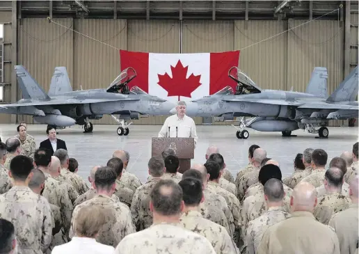  ?? SEAN KILPATRICK / THE CANADIAN PRES ?? “You stand on guard between the civilizati­on we enjoy and the savagery that seeks to come to our shores,’’ Prime Minister
Stephen Harper told troops at Camp Patrice Vincent on Sunday, during his whirlwind tour of Iraq and Kuwait.