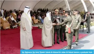  ??  ?? His Highness the Amir Sheikh Sabah Al-Ahmad Al-Jaber Al-Sabah honors a graduate from Ali Al-Sabah Military College.