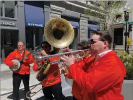  ?? STEVE LEBLANC — THE ASSOCIATED PRESS ?? Dan Gabel, right, and fellow musicians perform in downtown Boston, Tuesday. Gabel has canceled Netflix and other streaming services and tried to cut back on driving as the costs of gas, food, and other items, such as the lubricants he uses for his instrument­s, has soared. In the photo, from left to right, are Eric Baldwin, banjo; Ed Goroza, sousaphone; Josiah Reibstein, trombone; and Gabel, trumpet.