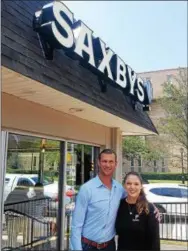  ?? BILL RETTEW JR. – DIGITAL FIRST MEDIA ?? Saxbys owner and founder Nick Bayer and Student Cafe Executive Officer Kelly Ingram pose outside the studentrun cafe across High Street from West Chester University.
