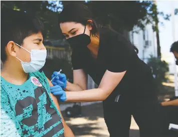  ?? PATRICK T. FALLON/AFP VIA GETTY IMAGES ?? A 12-year-old in Los Angeles receives a COVID-19 vaccine on the weekend. The vaccine has been approved in Canada for kids over 12, but B.C. has not yet announced plans for kids to be registered for the vaccinatio­n.