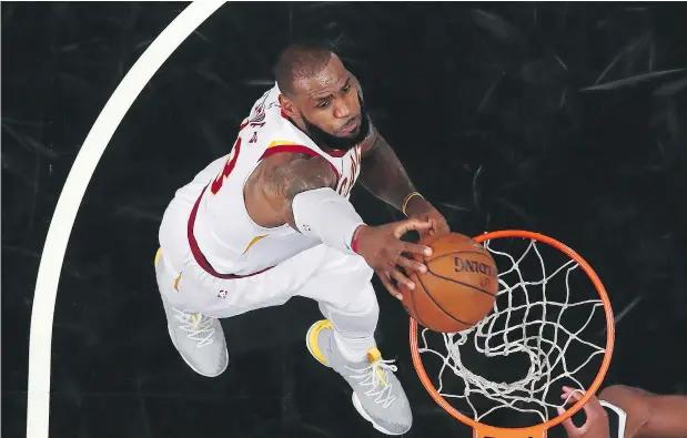  ?? AL BELLO / GETTY IMAGES ?? Nike is doing things differentl­y by releasing highly coveted Player Edition basketball shoes worn by LeBron James, above, to the public. Its LeBron Watch campaign, meanwhile, will give consumers access to the NBA star’s latest runners the minute he...