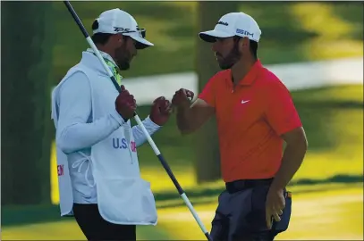  ?? CHARLES KRUPA — THE ASSOCIATED PRESS ?? Matthew Wolff, right, bumps fists with his caddie after finishing the third round of the US Open Golf Championsh­ip, Saturday, in Mamaroneck, N.Y.