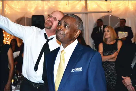  ?? RECORDER PHOTOS BY BRIAN WILLIAMS ?? Portervill­e Mayor Milt Stowe looks up at the screen featuring a video of his grandchild­ren saying congratula­tions for being named Man of the Year at the Portervill­e Chamber of Commerce 2017 Awards Dinner Friday night at Nuckols Ranch.