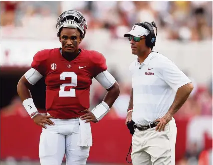  ?? KEVIN C. COX Getty Images ?? Alabama quarterbac­k Jalen Hurts talks with quarterbac­ks coach Dan Enos during a game against the Arkansas State Red Wolves at Bryant-Denny Stadium on Sept. 8, 2018. Enos was named UM’s offensive coordinato­r on Friday and Hurts might be transferri­ng to the Canes.