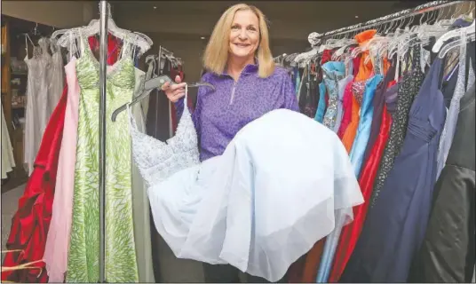  ??  ?? Jean Richardson shows off prom dresses in her north Cheyenne, Wyo., home. Richardson, the founder of Project Prom Cheyenne, has collected prom dresses for 15 years to give to students. “If I can take away that main expense of the dress, and (students) can afford to pay for the other things, that’s cool,” Richardson said.
(The Wyoming Tribune Eagle/Michael Cummo)