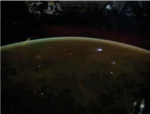  ?? NASA ?? Even at night, Earth is enveloped in the soft light of airglow, visible from the Internatio­nal Space Station as an orange-green aura.