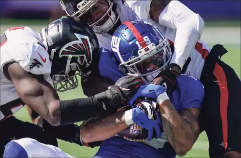  ?? Seth Wenig / Associated Press ?? New York Giants wide receiver Kenny Golladay (19) is tackled by Atlanta Falcons defensive back T.J. Green, right, during the second half on Sunday in East Rutherford, N.J.