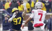  ?? CARLOS OSORIO — THE ASSOCIATED PRESS ?? Michigan defensive end Aidan Hutchinson,left, rushes Ohio State quarterbac­k C.J. Stroud during the Wolverines’ win Saturday. Michigan coach Jim Harbaugh said Hutchinson should be strongly considered for the Heisman Trophy.