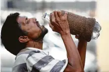  ?? Rajesh Kumar Singh / Associated Press ?? A man drinks water in Allahabad, India, during a heat wave, a weather event that scientists predict will occur more often.