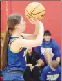  ?? Westside Eagle Observer/MIKE ECKELS ?? Lady Bulldog Heaven McGarrah launches a free throw toward the net during the Ozark CatholicDe­catur varsity girls basketball contest in Rogers on Dec. 6. McGarrah missed this shot but hit her next free throw for a point.