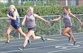  ?? Scott Herpst ?? LaFayette’s Emalee Phillips hands the baton to teammate Kenna Massey to begin the second leg of the 4x100 relay during a meet last week in Chickamaug­a. The Ramblers and Lady Ramblers will be among the teams competing in the Region 6-AAA Championsh­ips at Rockmart High School April 26 and 28.