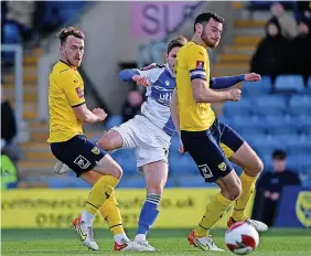  ?? ?? Sam Nicholson get s a shot away against Oxford at the Kassam Stadium